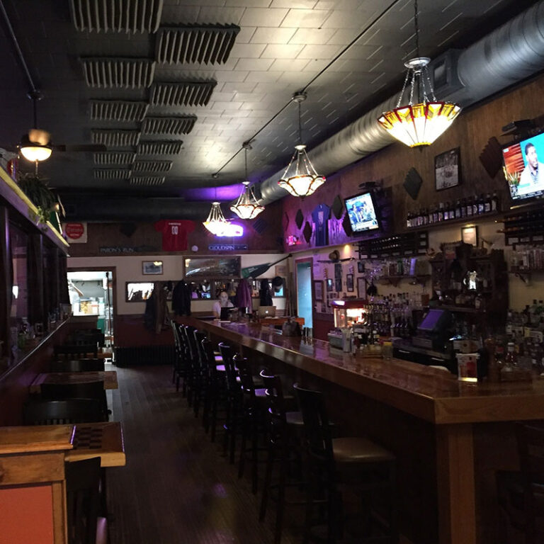 Downhill Grill wood bar with stools low light 768x768