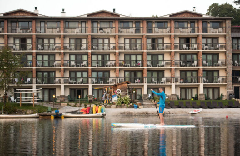 Golde Arrow Resort man paddle boating on lake 768x499